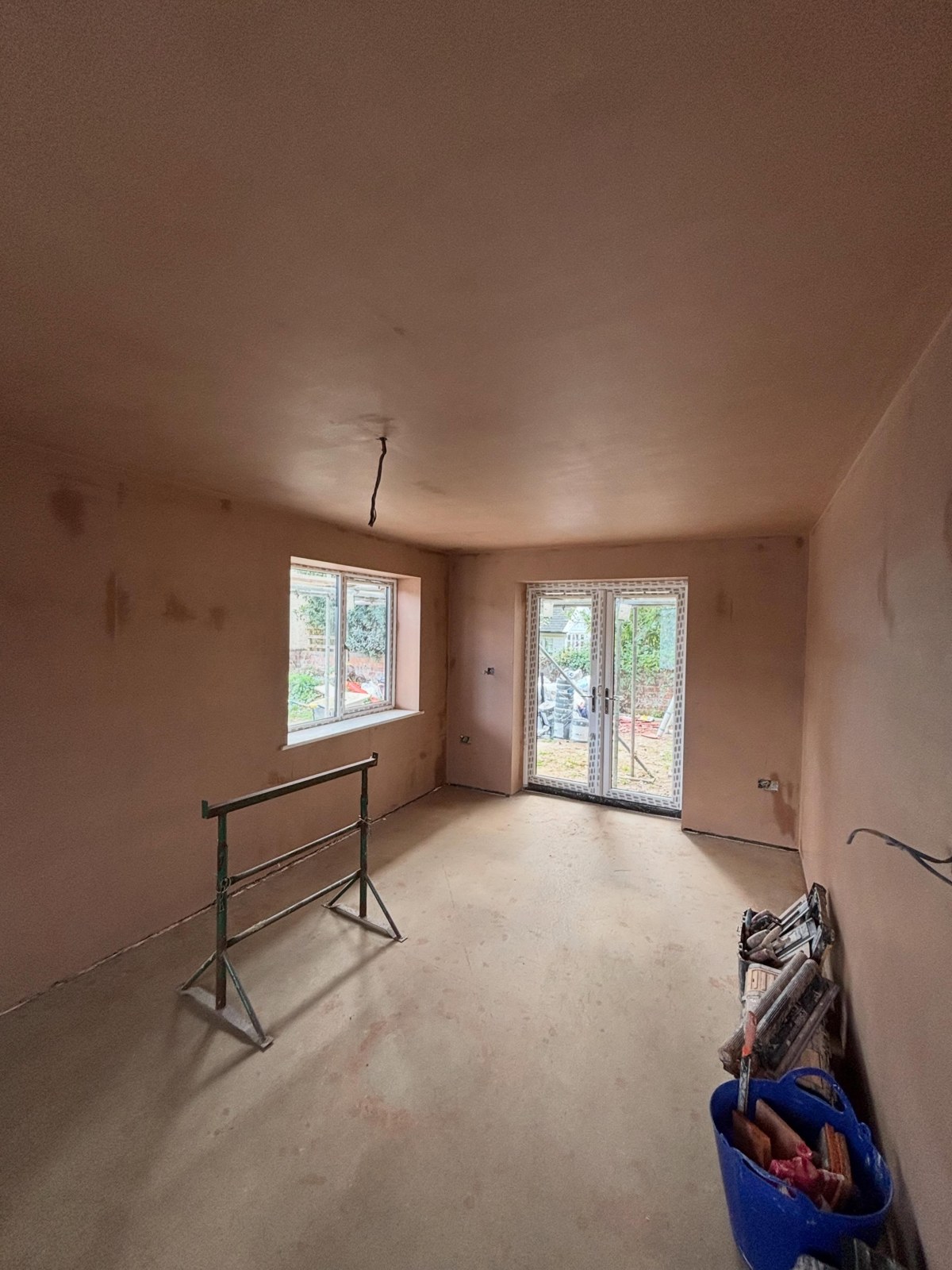 Dry lined and freshly plastered room with patio doors by Ash Plastering