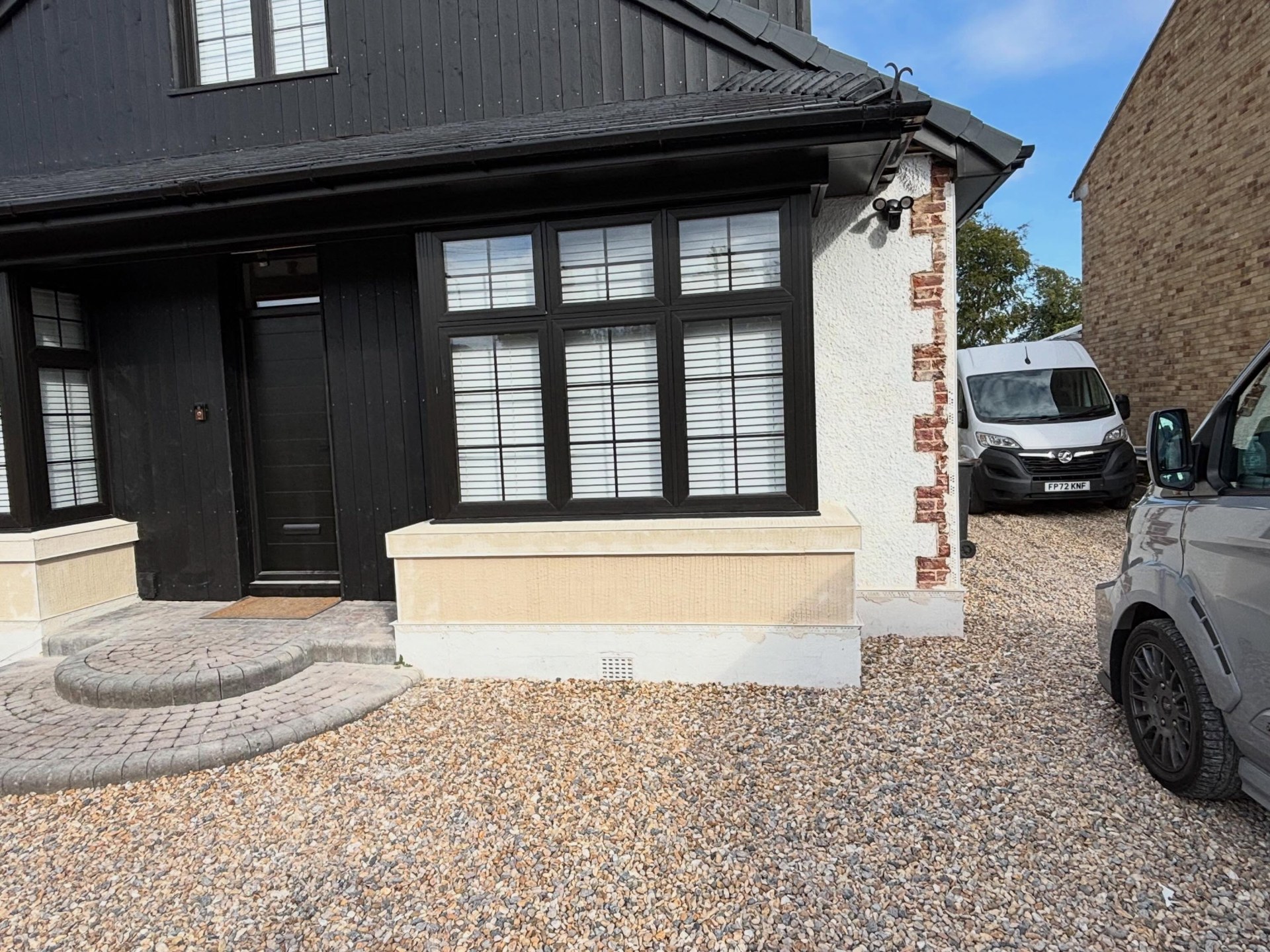 Property front prepared with beading and base coat for scrape-back render by Ash Plastering